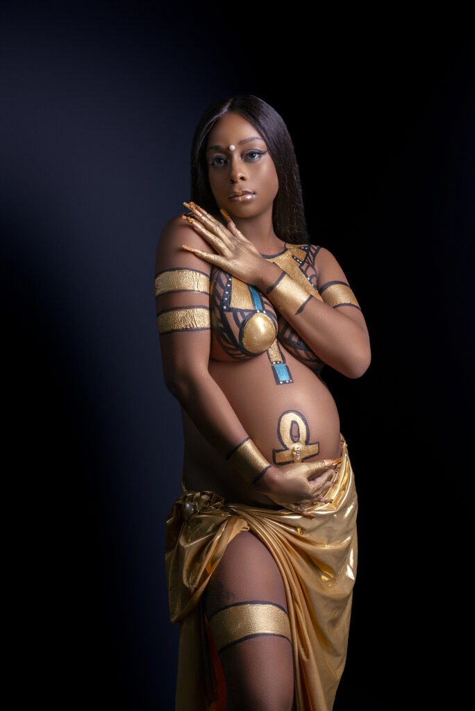 Posing creates a tone for the egyptian body paint maternity session 