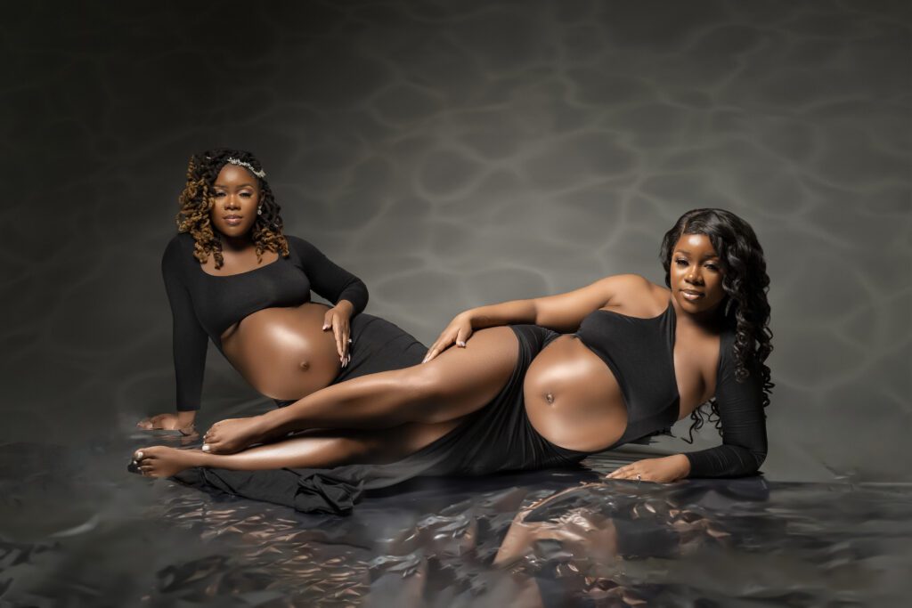 twin sisters pose for their maternity session as they make their motherhood debut